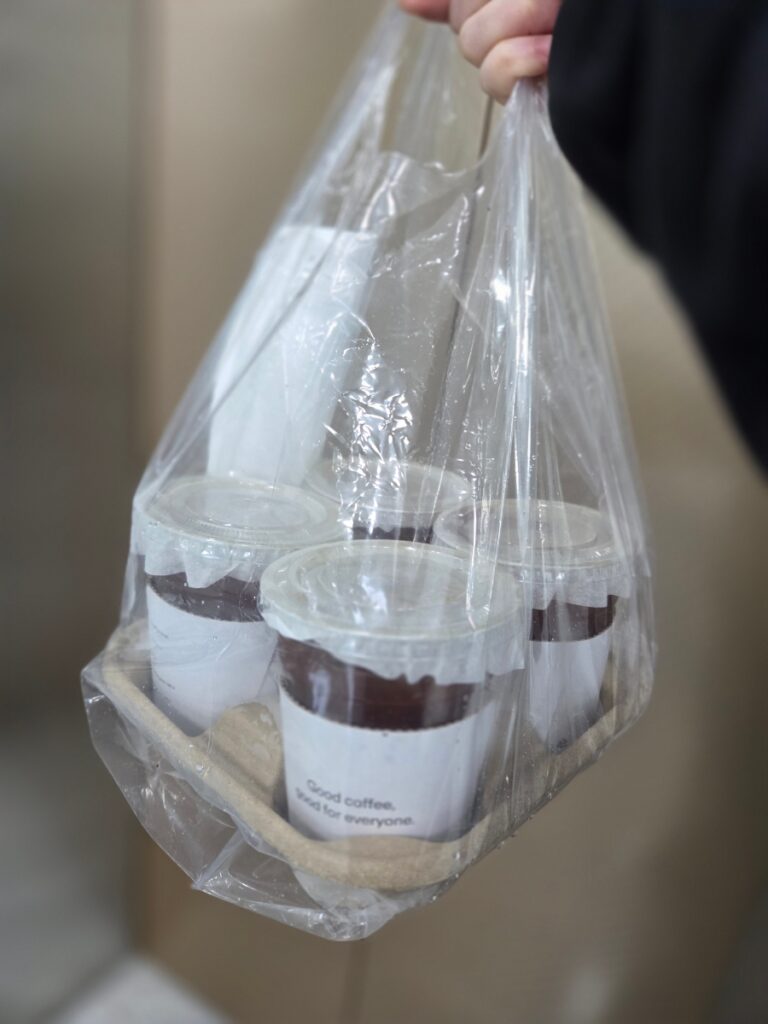 Iced Americano coffee in a plastic carrier bag before work in Korea