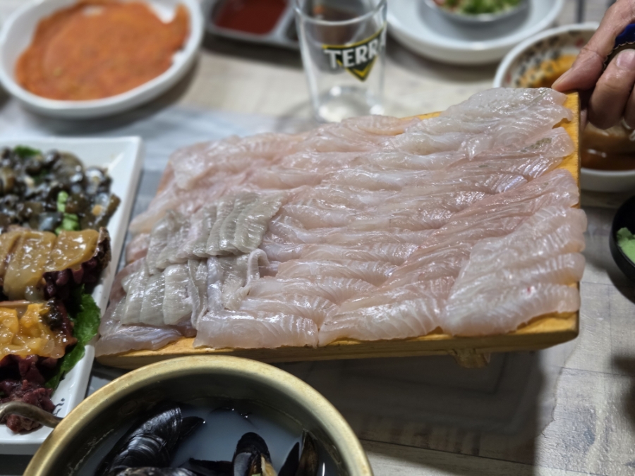 Fresh Korean flatfish sashimi served on a wooden board