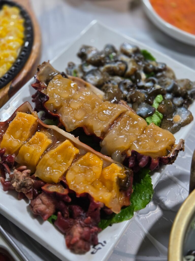 Korean seafood side dishes including sea squirt and sea cucumber